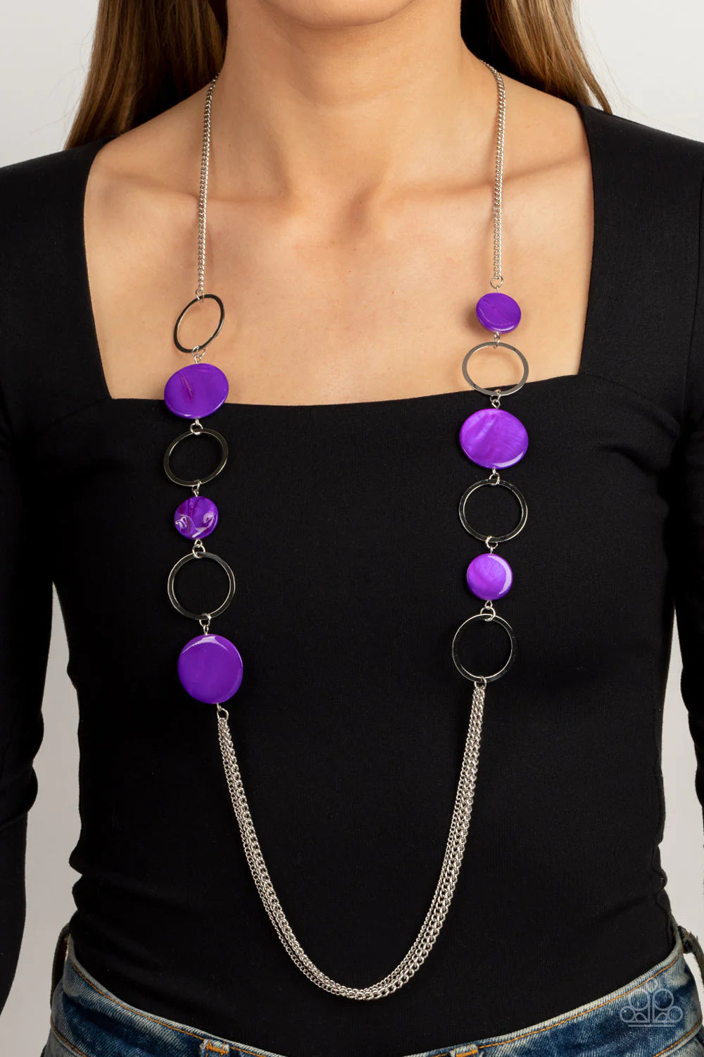 Paparazzi Accessories Beach Hub - Purple Sections of purple shell-like discs link with flat silver hoops down the chest, giving way to layers of shimmery silver chain for a tropical inspired flair. Features an adjustable clasp closure. Sold as one individ
