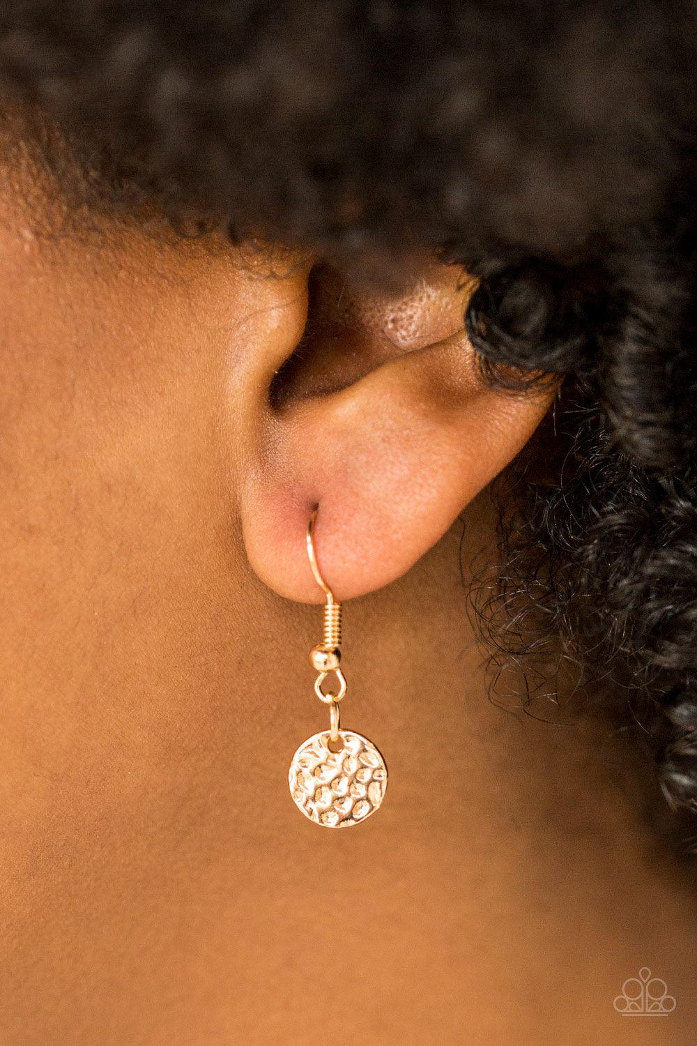 Paparazzi Accessories The BOLD Standard - Gold Delicately hammered in shimmery detail, a glistening gold pendant slides along a dainty gold box-chain below the collar for a bold look. Features an adjustable clasp closure. Sold as one individual necklace.