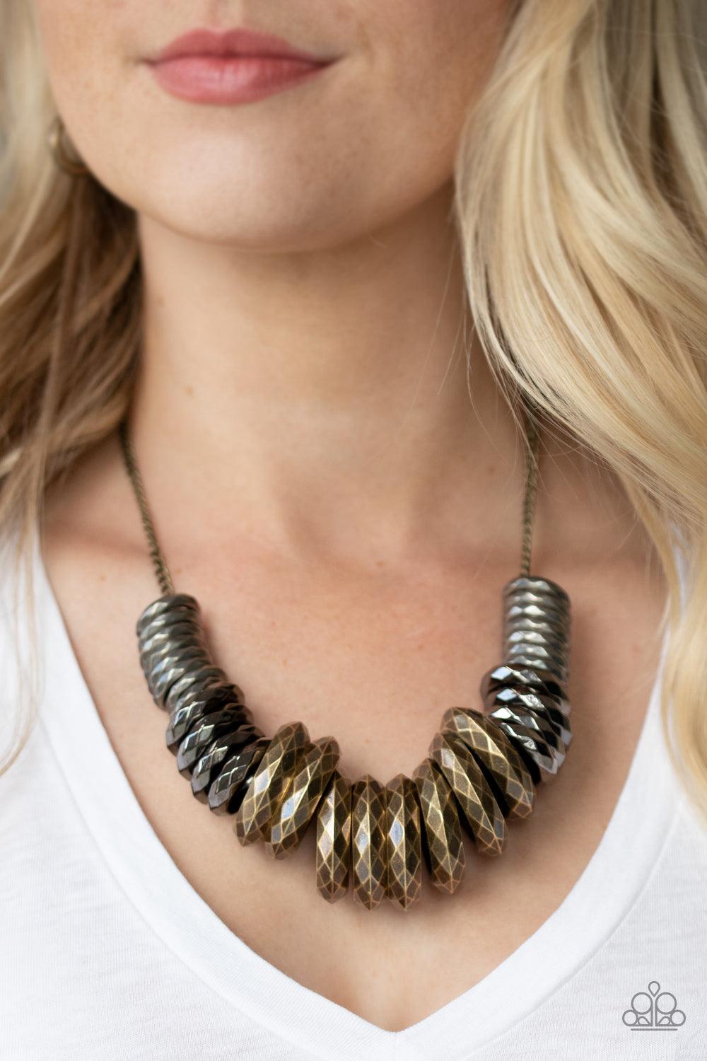 Paparazzi Accessories Haute Hardware - Multi Gradually increasing in size, a collision of faceted tin finished silver, gunmetal, and brass rings slide along a classic brass chain below the collar for a bold industrial look. Features an adjustable clasp cl