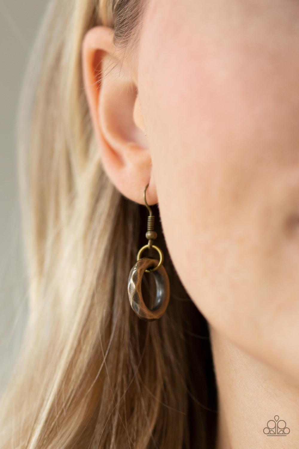 Paparazzi Accessories Haute Hardware - Multi Gradually increasing in size, a collision of faceted tin finished silver, gunmetal, and brass rings slide along a classic brass chain below the collar for a bold industrial look. Features an adjustable clasp cl