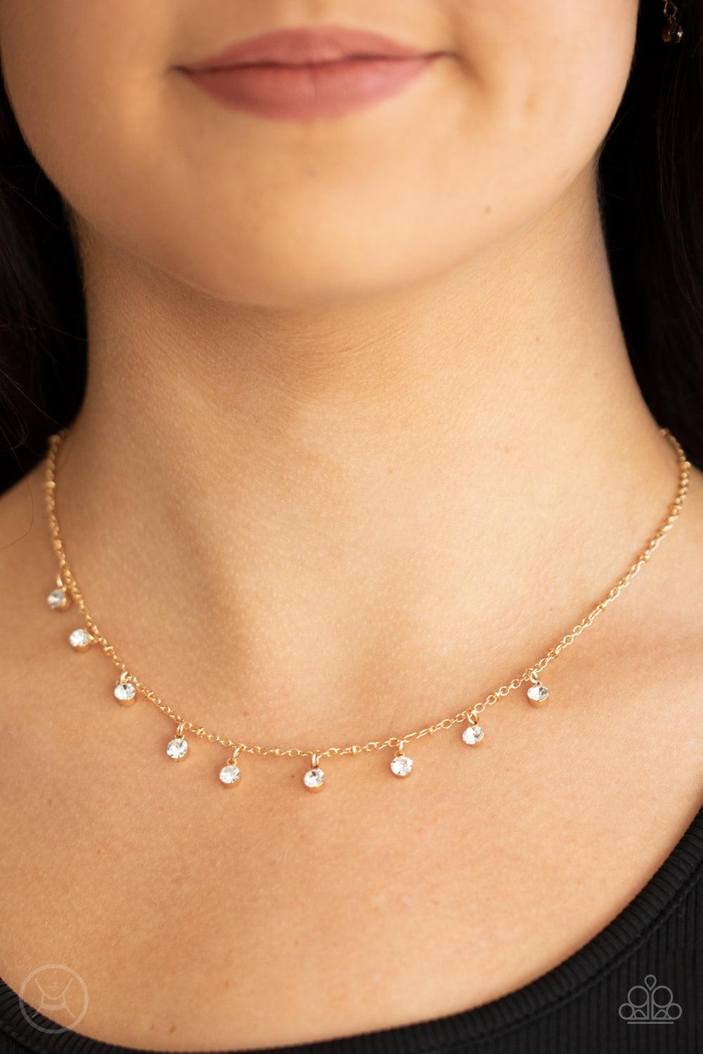 Paparazzi Accessories Dainty Diva - Gold Glassy white rhinestones swing from a dainty gold chain, creating a glamorous fringe around the neck. Features an adjustable clasp closure. Sold as one individual choker necklace. Includes one pair of matching earr