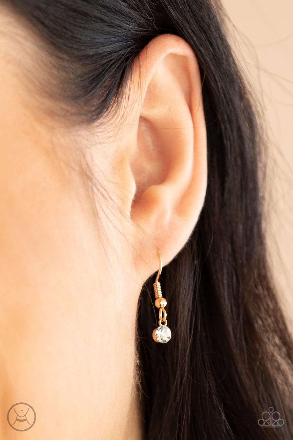 Paparazzi Accessories Dainty Diva - Gold Glassy white rhinestones swing from a dainty gold chain, creating a glamorous fringe around the neck. Features an adjustable clasp closure. Sold as one individual choker necklace. Includes one pair of matching earr