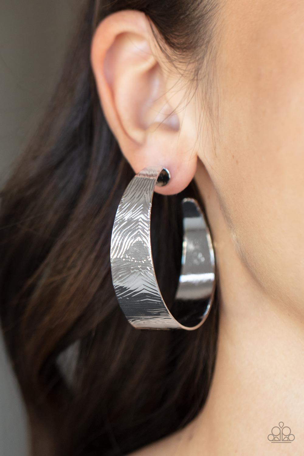 Paparazzi Accessories Curve Crushin - Silver Embossed in whirling geometric details, a thick silver hoop boldly curls around the ear for a curvaceous look. Earring attaches to a standard post fitting. Hoop measures approximately 2" in diameter. Sold as on