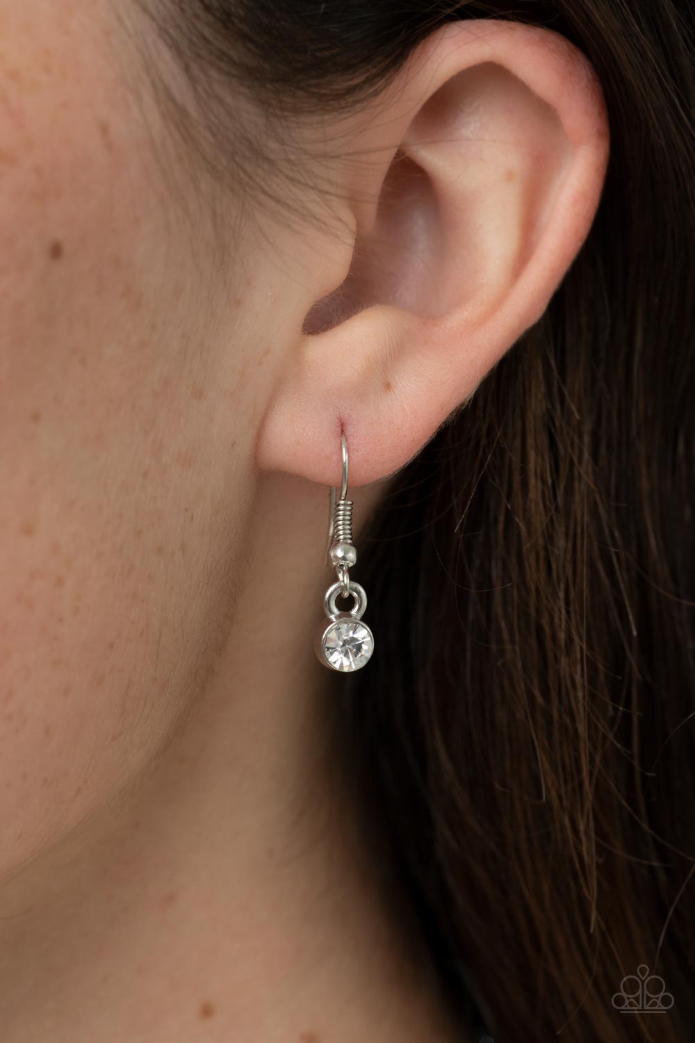 Paparazzi Accessories Understated Dazzle - Black Featuring a white rhinestone encrusted silver fitting, an oversized emerald cut black rhinestone swings from the bottom of a dainty silver chain below the collar for a glamorous fashion. Features an adjusta