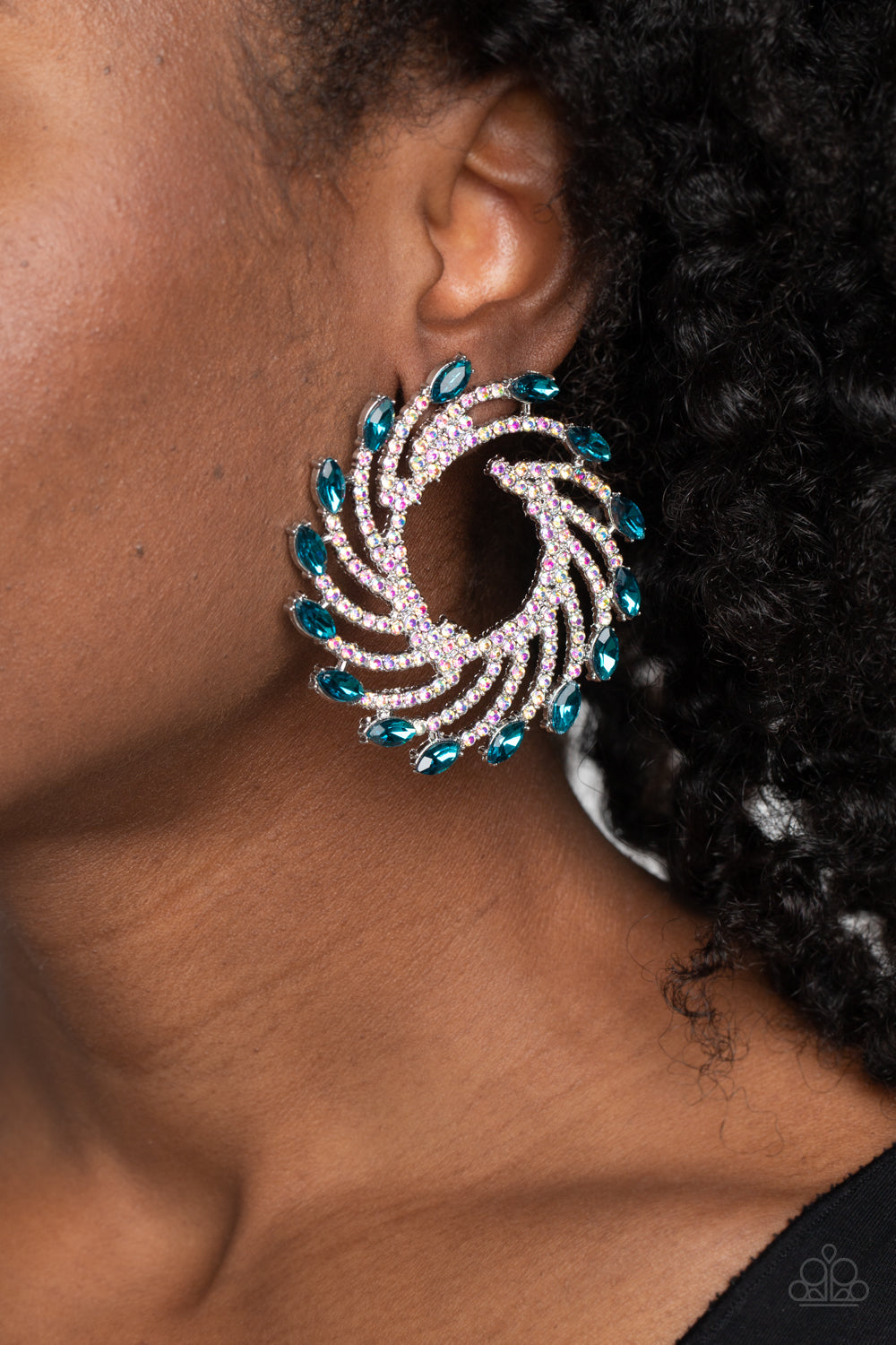 Paparazzi Accessories Firework Fanfare - Blue Shimmery strands of silver spin out from an airy center, creating an exaggerated firework-like display at the ear. An explosion of dainty iridescent rhinestones lines the swirls and curves of the shimmery disp