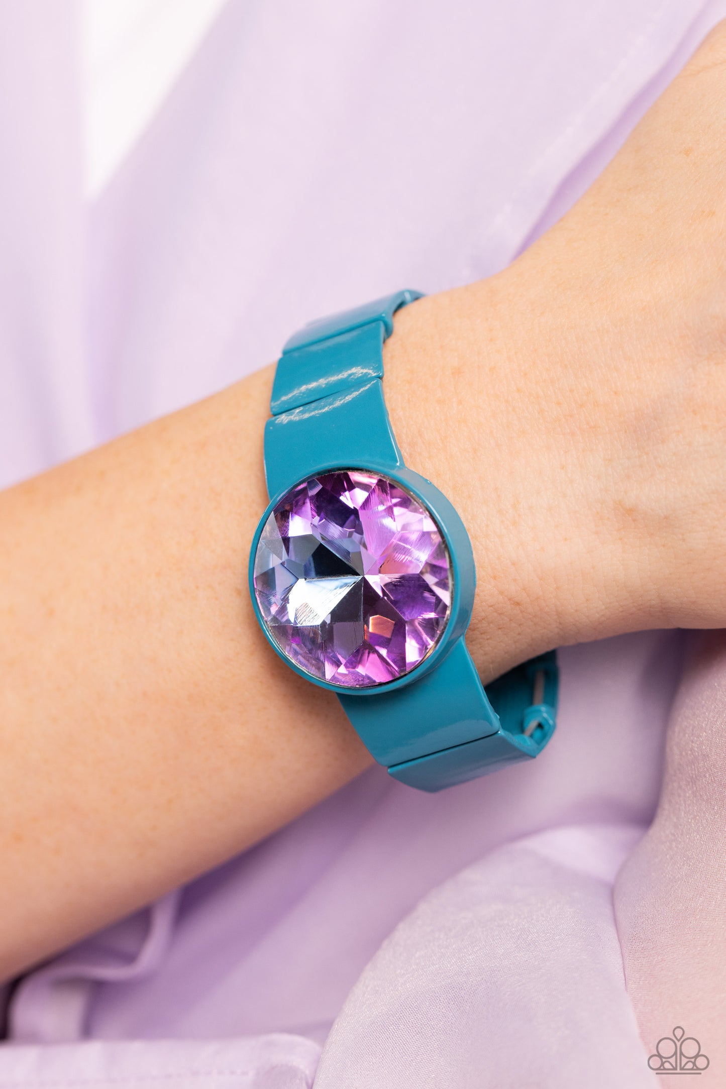 Paparazzi Accessories Exaggerated Ego - Blue Featuring a UV shimmer, an exaggerated purple gem is pressed into a metallic blue fitting along bold rectangular frames around the wrist on stretchy bands for a colorful summer look. Sold as one individual brac