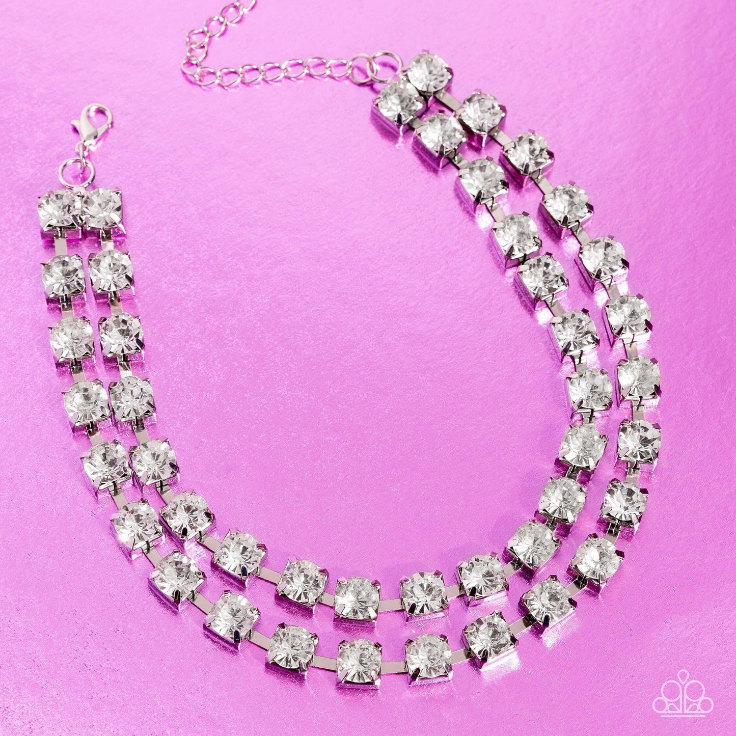 Paparazzi Accessories Glistening Gallery - White Featuring pronged silver fittings, strands of oversized, glittery white rhinestones connect with rows of silver box chains around the neck for a glittery twist. Features an adjustable clasp closure. Sold as
