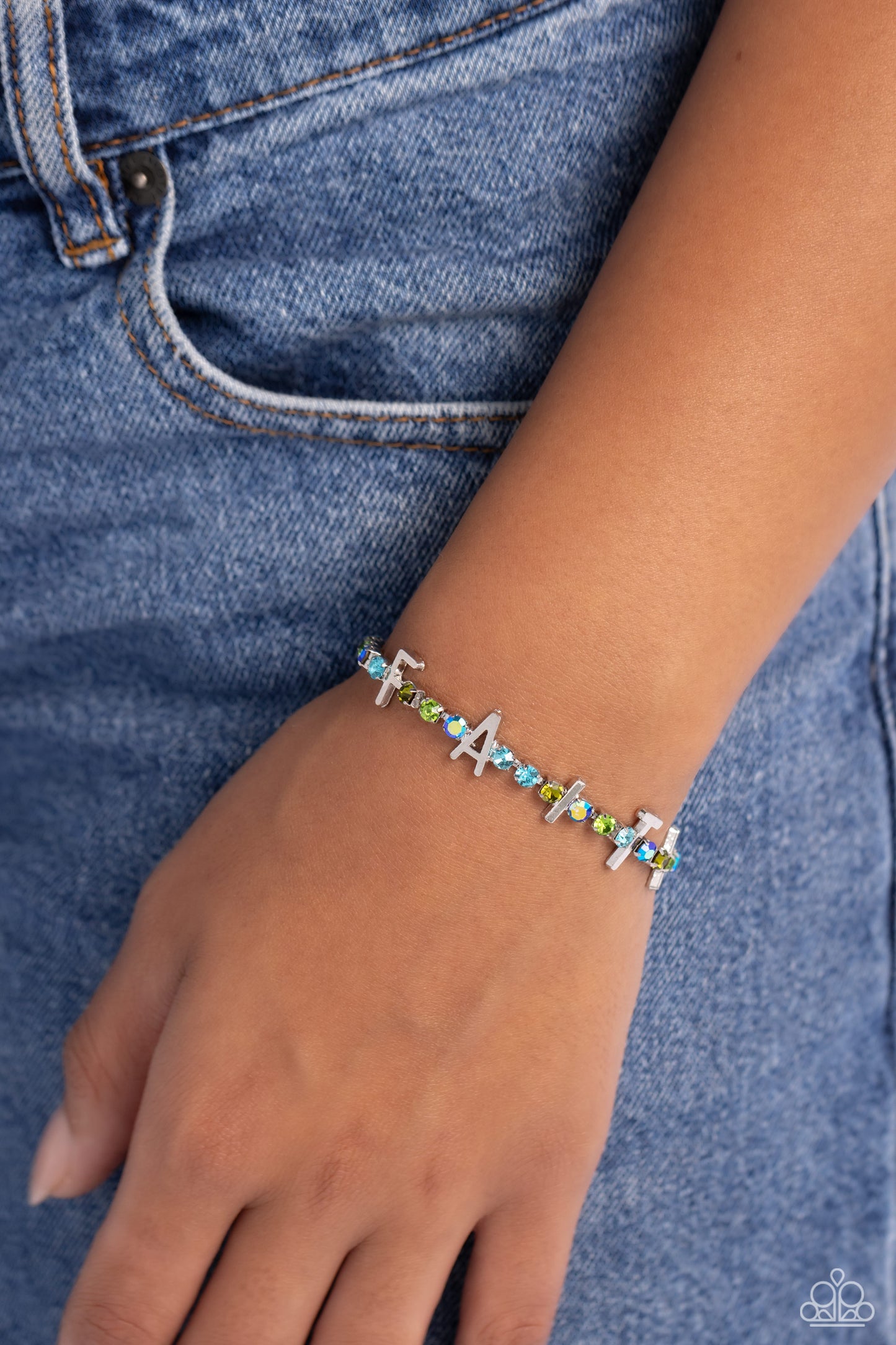 Paparazzi Accessories In Good Faith - Multi Set in silver square fittings, various multicolored rhinestones gleam around the wrist. Infused along the design, sleek silver letters spell out the word "FAITH" for an inspirational finish. Features an adjustab