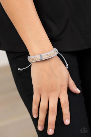 Paparazzi Accessories Guided Expedition Glimmering metallic thread is braided with natural twine and laced to the top of a lavender leather band creating a rustic homespun style around the wrist. Features an adjustable sliding knot closure. Sold as one in