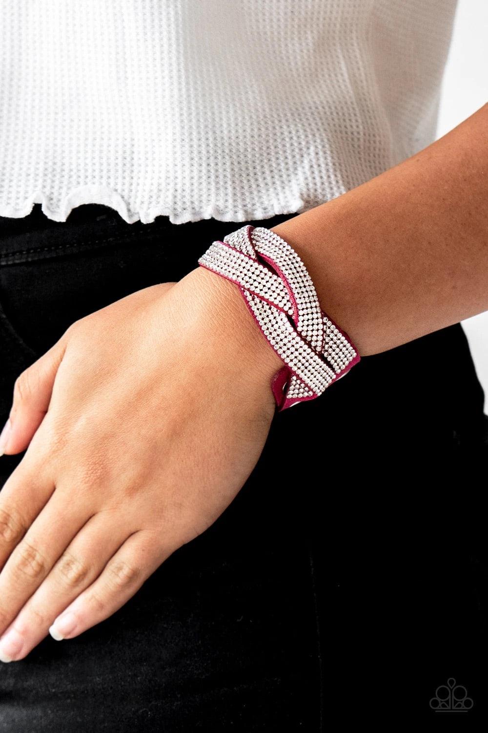 Paparazzi Accessories Nice Girls Finish Last - Pink Encrusted in row after row of glittery white rhinestones, three pink suede bands braid across the wrist for a sassy look. Features an adjustable snap closure. Sold as one individual bracelet. Jewelry
