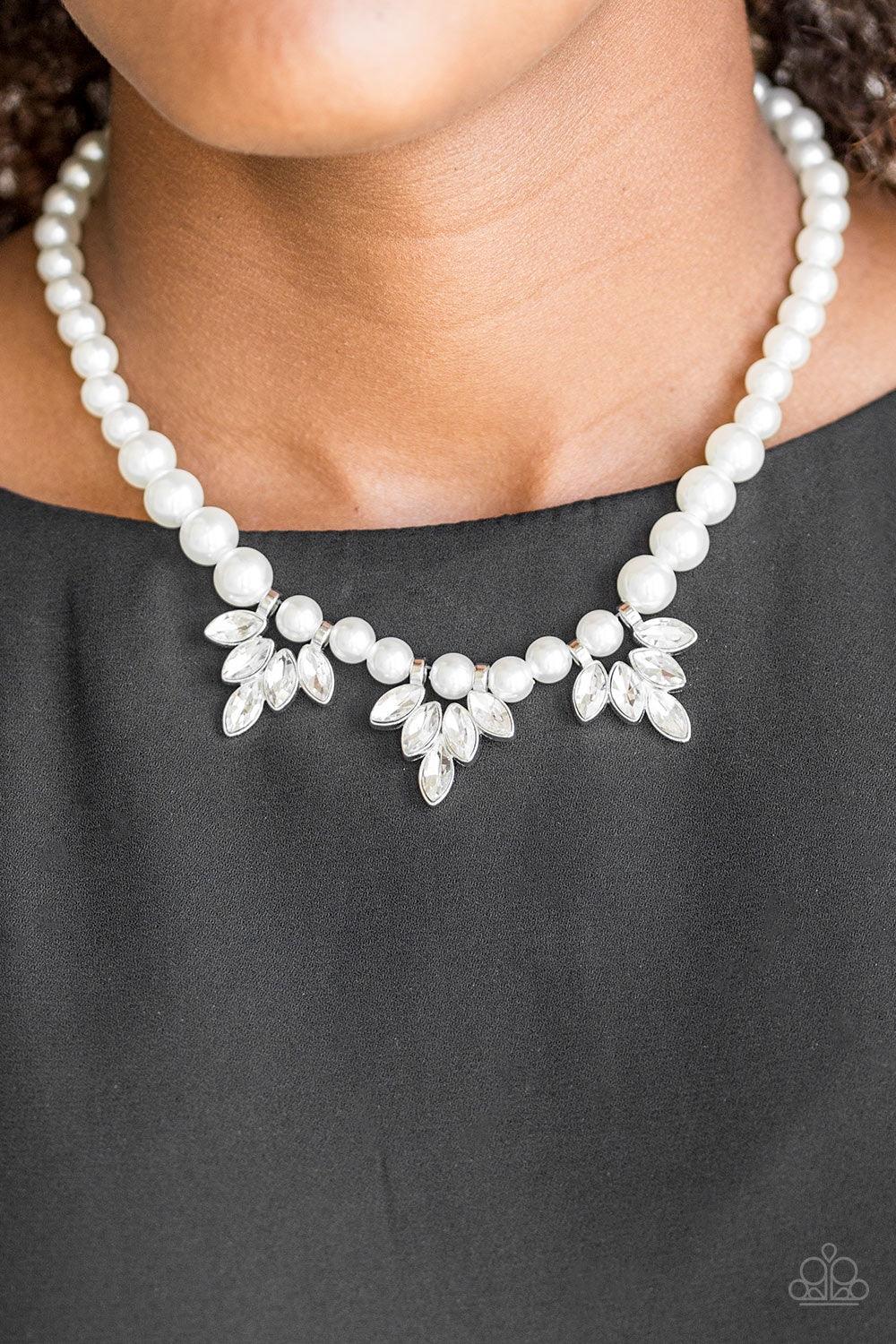 Paparazzi Accessories Society Socialite - White A strand of classic white pearls drapes elegantly below the collar. Featuring regal marquise style cuts, glittery white rhinestone frames swing from the pearls for a timeless finish. Features an adjustable c