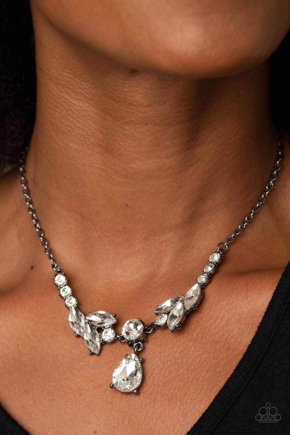 Paparazzi Accessories Unrivaled Sparkle - Black Tiers of white rhinestone encrusted frames delicately link below the collar, giving way to an oversized white teardrop rhinestone pendant for a timeless finish. Features an adjustable clasp closure. Sold as