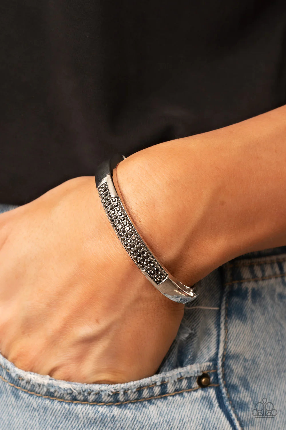 Paparazzi Accessories Chart-Topping Twinkle - Silver The front of a silver frame is chiseled away, revealing two rows of glitzy hematite rhinestones across the center of a gritty bangle-like bracelet. Features a hinged closure. Sold as one individual brac