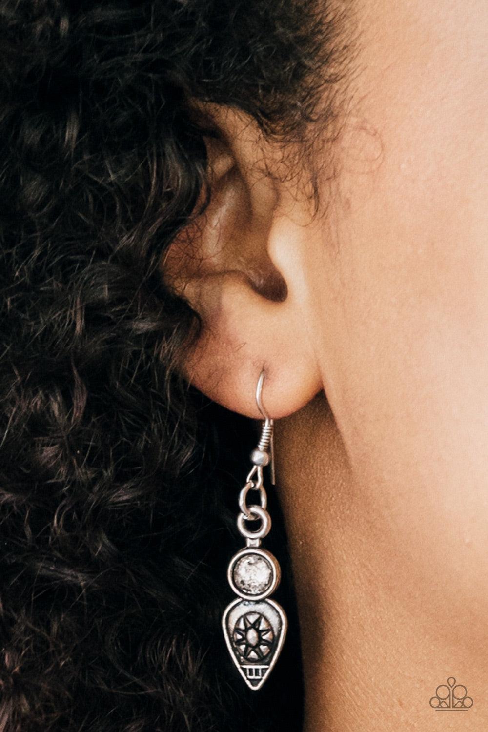 Paparazzi Accessories The Desert is Calling - Silver Stenciled in tribal inspired details, shimmery silver plates connect below the collar, coalescing into a crescent pendant. Embossed and studded in ornate patterns, antiqued silver beads swing from the b