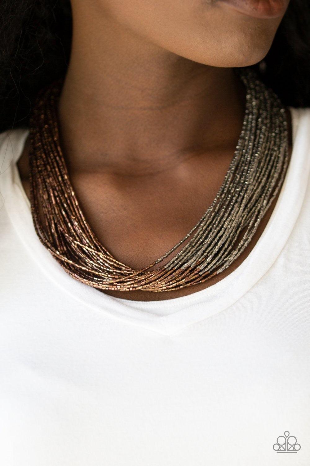 Paparazzi Accessories Flashy Fashion - Copper Brushed in a flashy metallic finish, countless strands of copper seed beads converge with strands of gunmetal seed beads, creating colorful layers below the collar. Features an adjustable clasp closure. Sold a