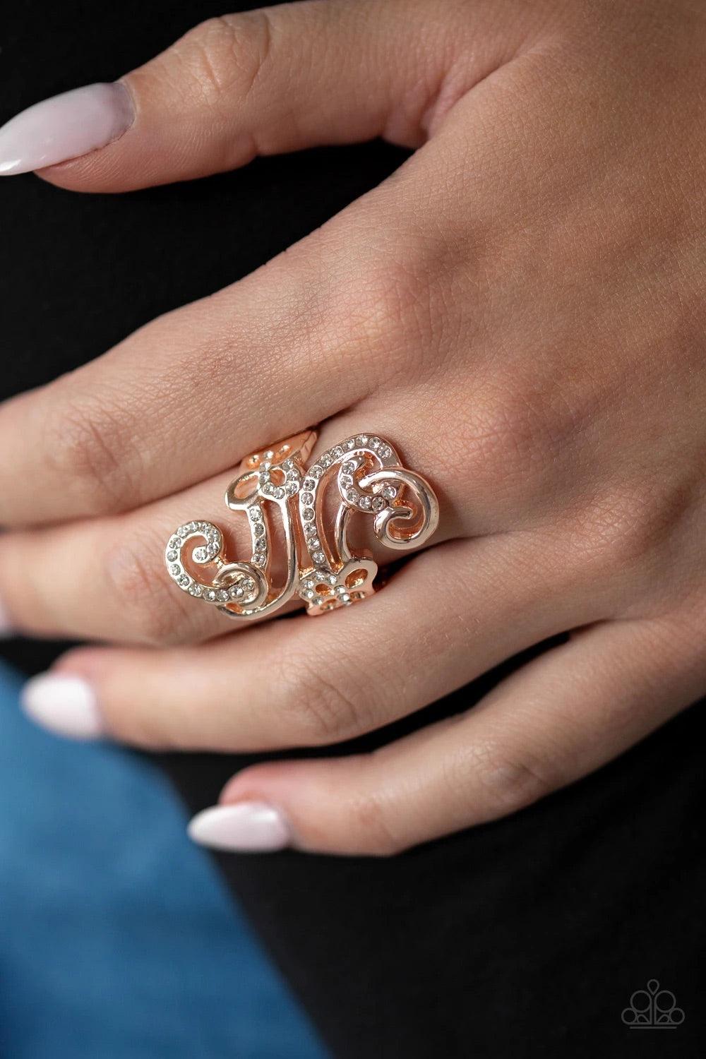 Paparazzi Accessories Waltzing Wonder ~Gold Encrusted in glassy white rhinestones, a sparkling ribbon intertwines with a smooth rose gold ribbon, swirling into a whirl of dainty butterfly frames. Features a stretchy band for a flexible fit. Sold as one in
