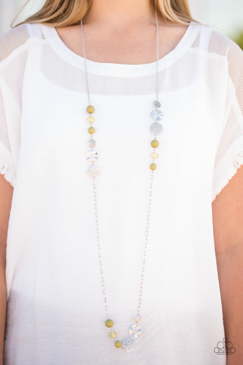 Paparazzi Accessories Midnight Musical - Green Stenciled and hammered silver accents trickle along a shimmery silver chain. Crystal-like and polished green beading join the metallic accents, adding a neutral pop of color to the whimsical palette. Features