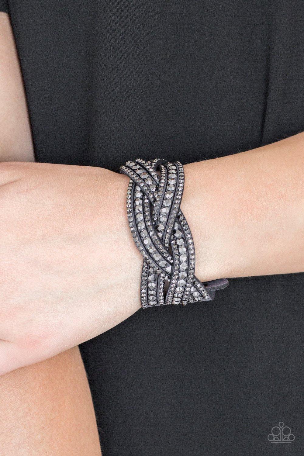 Paparazzi Accessories Bring on the Bling - Silver 2 Varying in size, glittery hematite rhinestones are encrusted along interwoven gray suede bands, creating blinding shimmer across the wrist. Features an adjustable snap closure. Sold as one individual bra
