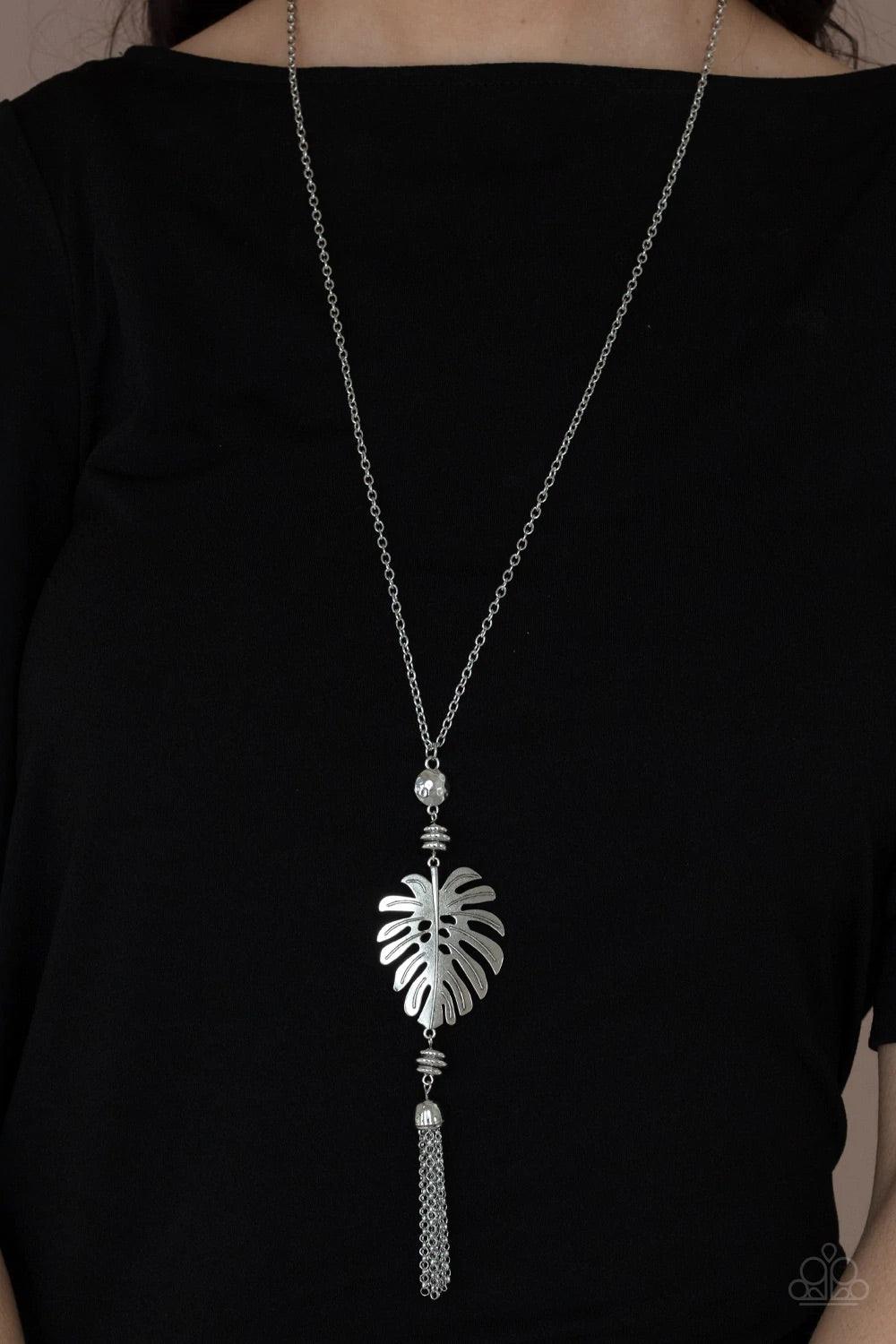 Paparazzi Accessories Palm Promenade - Silver Infused with silver beaded accents, a lifelike silver palm leaf frame attaches to the bottom of a shimmery silver chain. A silver chain tassel swings from the bottom, adding flirtatious movement to the summery