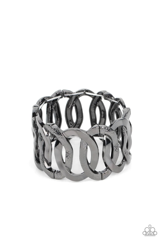 Paparazzi Accessories Industrial Indulgence - Black Large gunmetal hoops brushed in glittery, gritty texture alternate with smooth gunmetal hoops featuring a high sheen finish. The oversized links overlap as they alternate around the wrist on stretchy ban