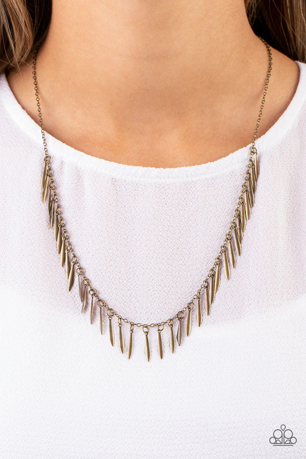 Paparazzi Accessories Striking Sheen - Brass Dainty brass bars with a subtle curvature along their center, dance vivaciously along a brass chain to create a fierce fringe along the neckline. Each brass bar is flared at the bottom, expanding its light-catc