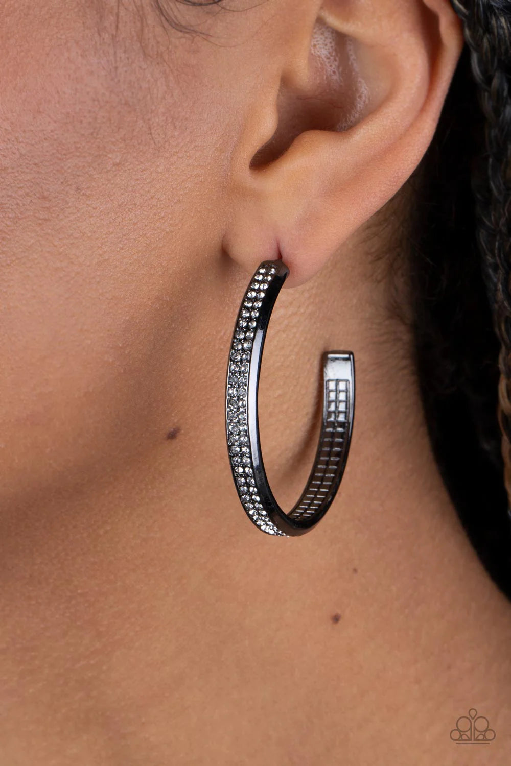Paparazzi Accessories Flash Freeze - Black Two rows of glitzy white rhinestones are encrusted along the outside curve of a gritty gunmetal hoop, creating an understated rocker look. Earring attaches to a standard post fitting. Hoop measures approximately