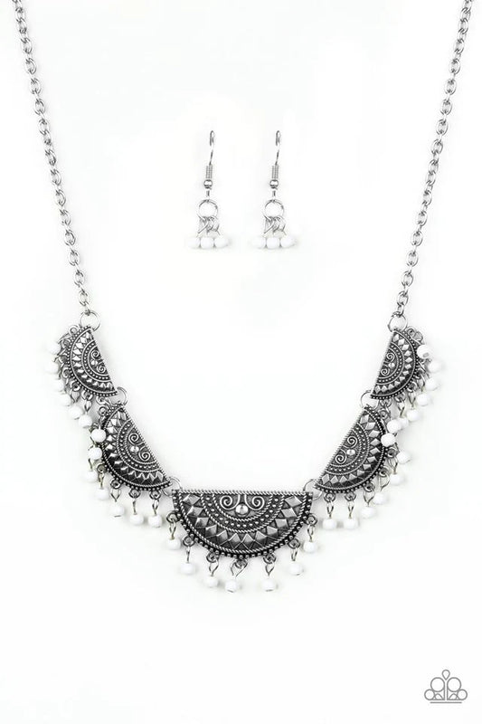 Paparazzi Accessories Boho Baby - White Embossed in tribal inspired patterns, silver half-moon frames link below the collar. Dainty white beads swing from the bottoms of the ornate frames, creating a flirtatious fringe. Features an adjustable clasp closur