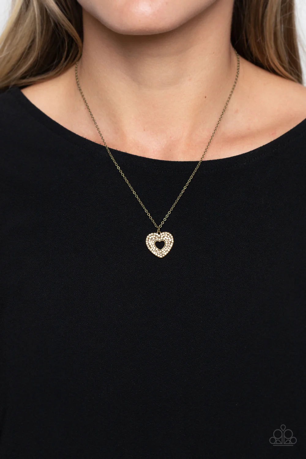 Paparazzi Accessories Romantic Retreat - Brass Bordered in stacked rows of dainty, glassy topaz rhinestones, a twinkly brass heart-shaped silhouette frame sparkles at the center of a dainty brass chain for a romantic finish. Features an adjustable clasp c