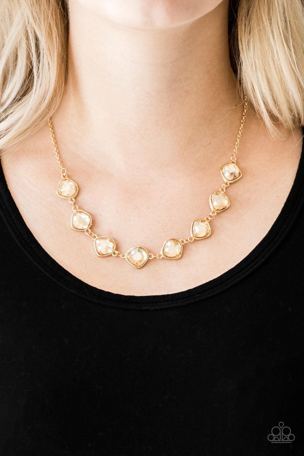 Paparazzi Accessories The Imperfectionist - Gold Featuring shimmery gold frames, imperfect golden gems link below the collar for a glamorous vintage inspired look. Features an adjustable clasp closure. Sold as one individual necklace. Includes one pair of