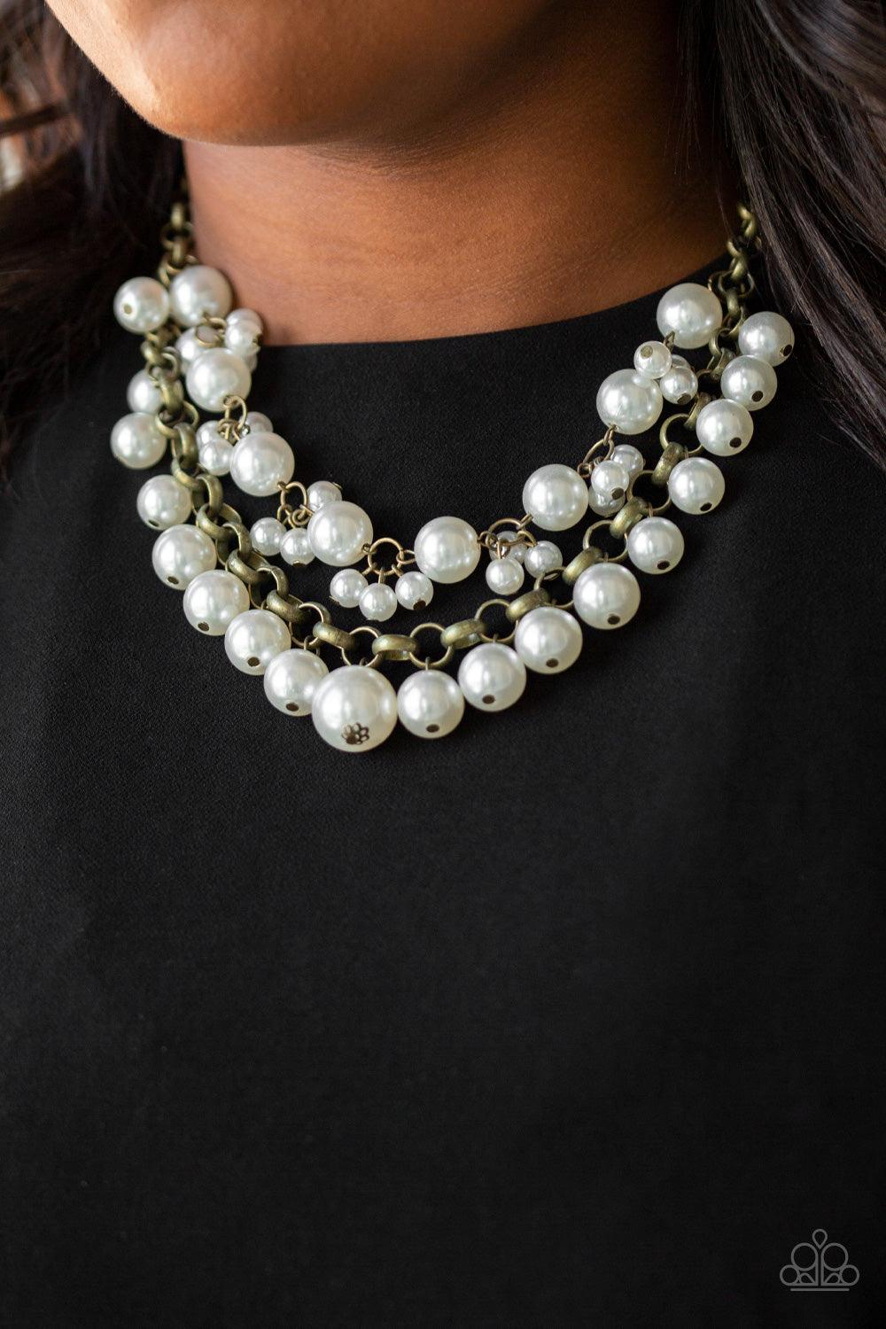 Paparazzi Accessories BALLROOM Service - Brass Two rows of mismatched white pearls gorgeously drape below the collar. Featuring oversized brass links and an assortment of pearl sizes, the bubbly strands layer into a dramatic fringe for a modern timelessne