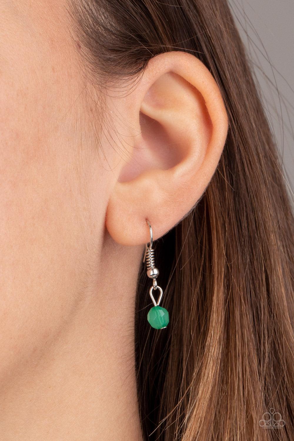 Paparazzi Accessories Tassel Takeover - Green Green opaque crystal-like beads, shiny silver beads, and white rhinestone encrusted rings give way to a shimmery silver tassel for a whimsical look. Features an adjustable clasp closure. Sold as one individual