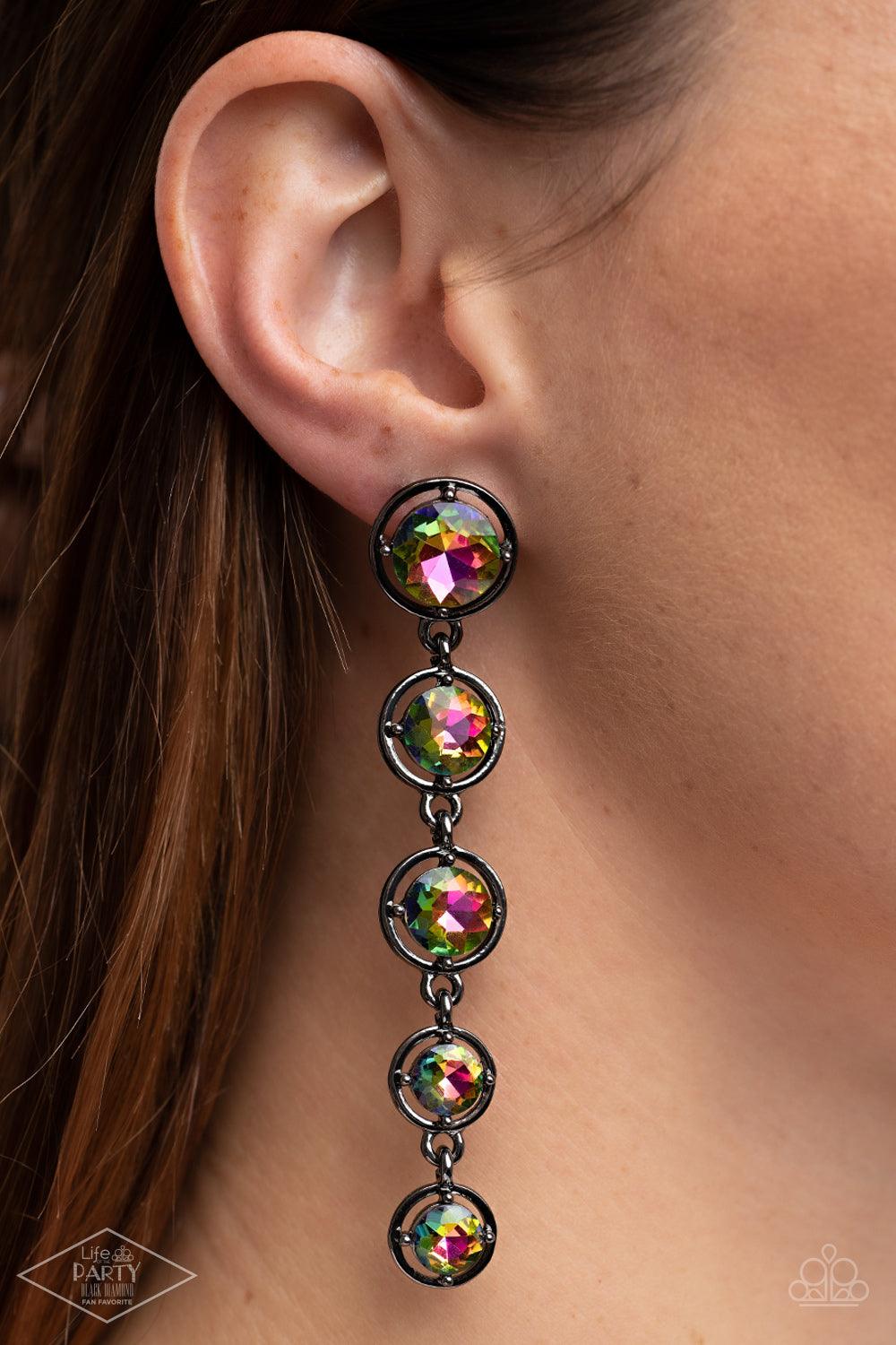 Paparazzi Accessories Drippin In Starlight - Multi Featuring sleek gunmetal fittings, faceted rainbow gems gradually decrease as they trickle from the ear for a glamorous look. Earring attaches to a standard post fitting. Sold as one pair of post earrings