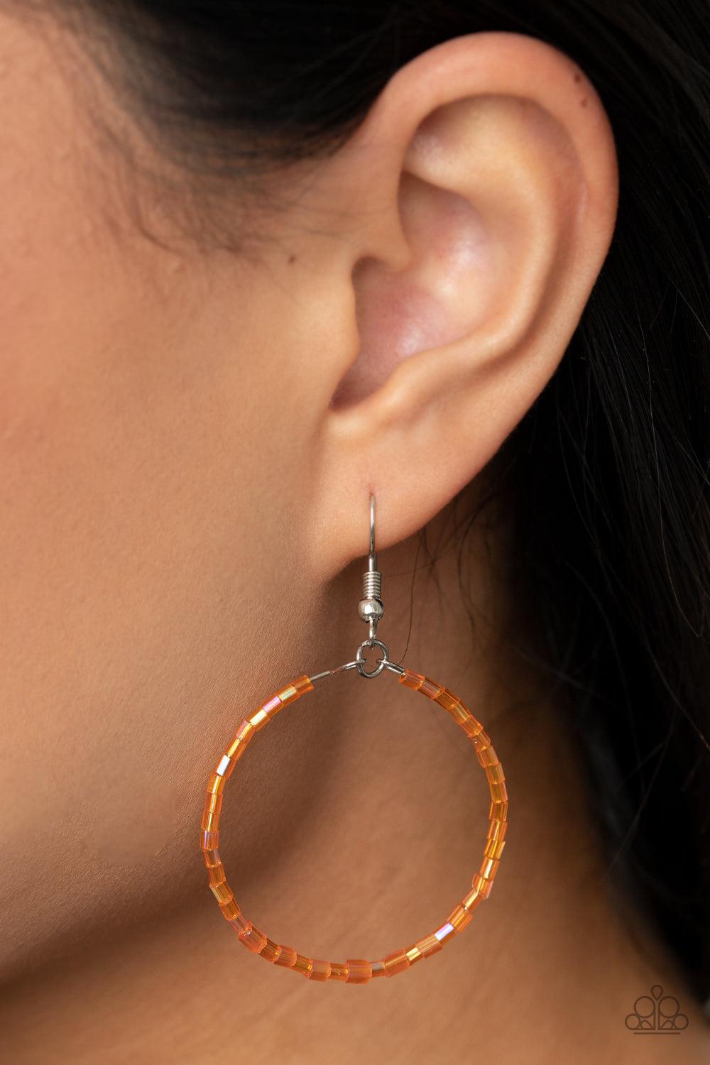 Paparazzi Accessories Colorfully Curvy - Orange Featuring an iridescent shimmer, glassy orange seed beads are threaded along a dainty wire hoop for a colorful finish. Earring attaches to a standard fishhook fitting. Sold as one pair of earrings. Jewelry
