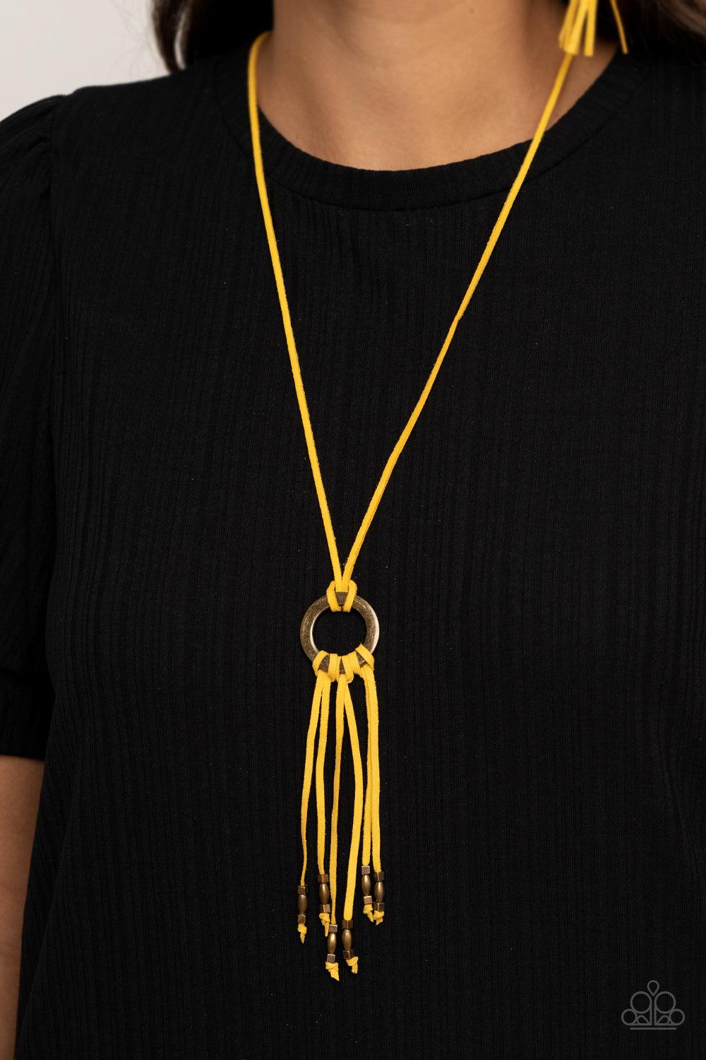 Paparazzi Accessories Feel at HOMESPUN - Yellow Infused with dainty brass beads, strands of yellow suede knot at the bottom of an antiqued brass ring, creating a colorfully rustic tassel at the bottom of a lengthened strand of yellow suede. Features an ad