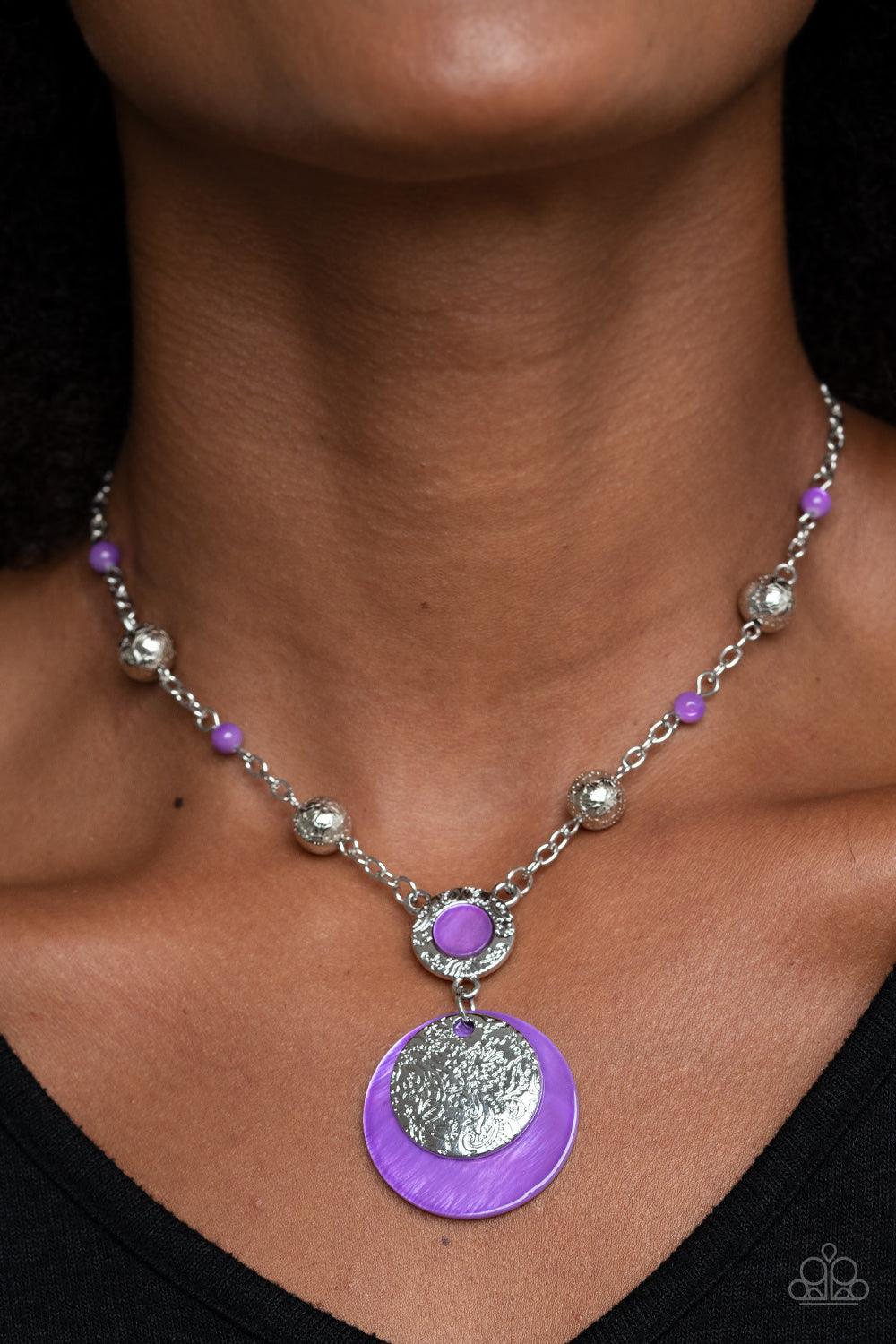 Paparazzi Accessories SEA The Sights - Purple A dainty collection of ornate silver beads and purple stone beads dot a dainty silver chain, giving way to a hammered silver ring featuring a shell-like center. A hammered silver disc and purple shell-like dis
