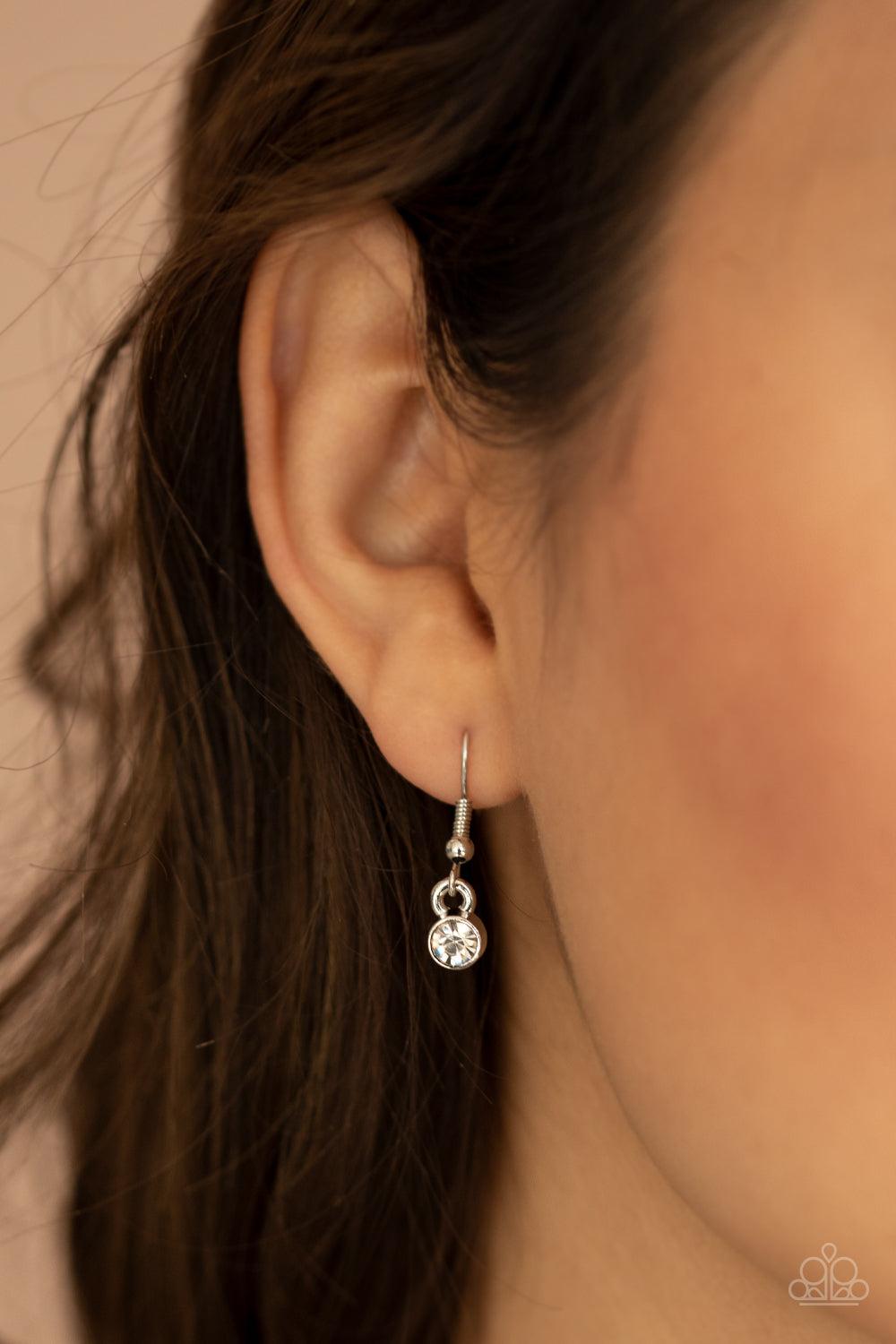 Paparazzi Accessories Never SLAY Never - White An oversized collection of round, marquise, and teardrop white rhinestones drip from the bottom of a bowing silver bar, coalescing into a sassy statement piece below the collar. Features an adjustable clasp c