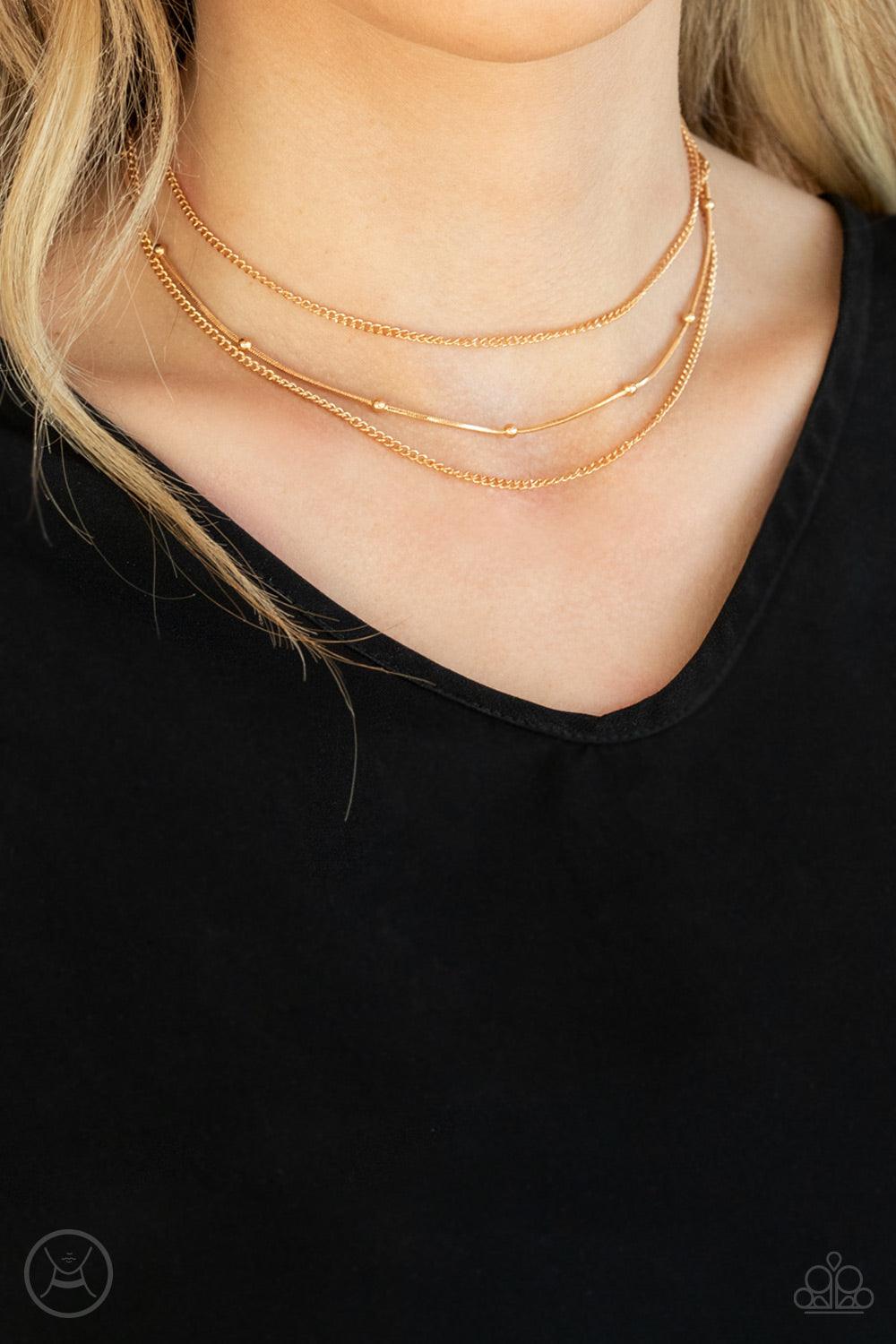 Paparazzi Accessories Subtly Stunning - Gold Infused with two dainty gold chains, a gold beaded snake chain wraps around the neck for a stunning layered look. Features an adjustable clasp closure. Sold as one individual choker necklace. Includes one pair