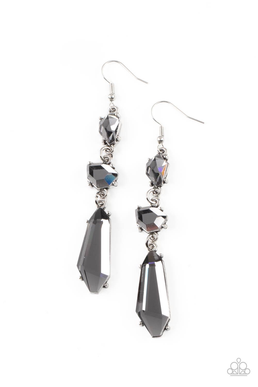 Paparazzi Accessories Sophisticated Smolder - Silver Featuring raw cuts, an asymmetrical collection of faceted smoky gems trickles from the ear, creating a smoldering chandelier. Earring attaches to a standard fishhook fitting. Sold as one pair of earring