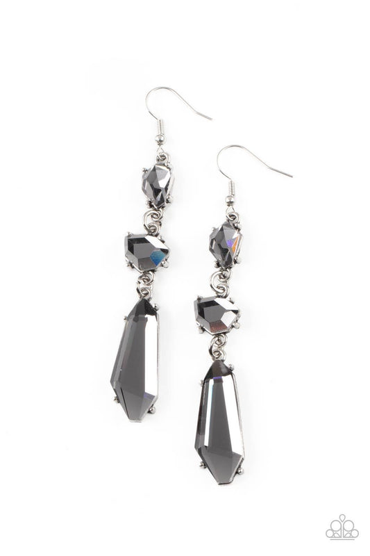 Paparazzi Accessories Sophisticated Smolder - Silver Featuring raw cuts, an asymmetrical collection of faceted smoky gems trickles from the ear, creating a smoldering chandelier. Earring attaches to a standard fishhook fitting. Sold as one pair of earring