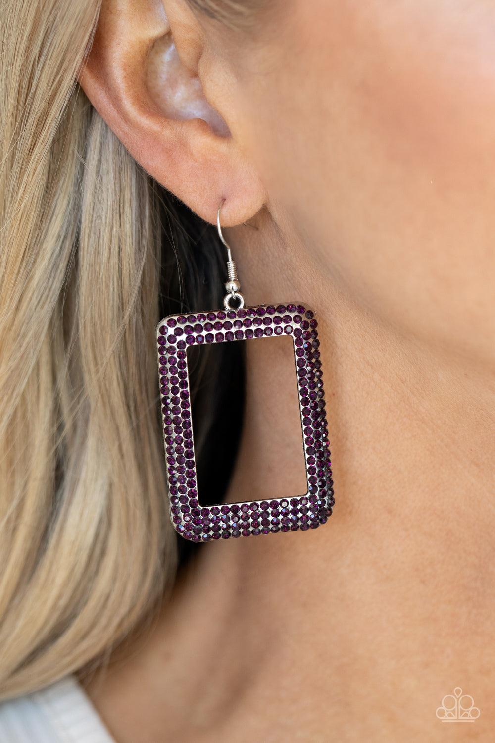 Paparazzi Accessories World FRAME-ous - Purple Bordered in rows of glittery purple rhinestones, an oversized silver rectangular frame swings from the ear for a fashionable finish. Earring attaches to a standard fishhook fitting. Sold as one pair of earrin