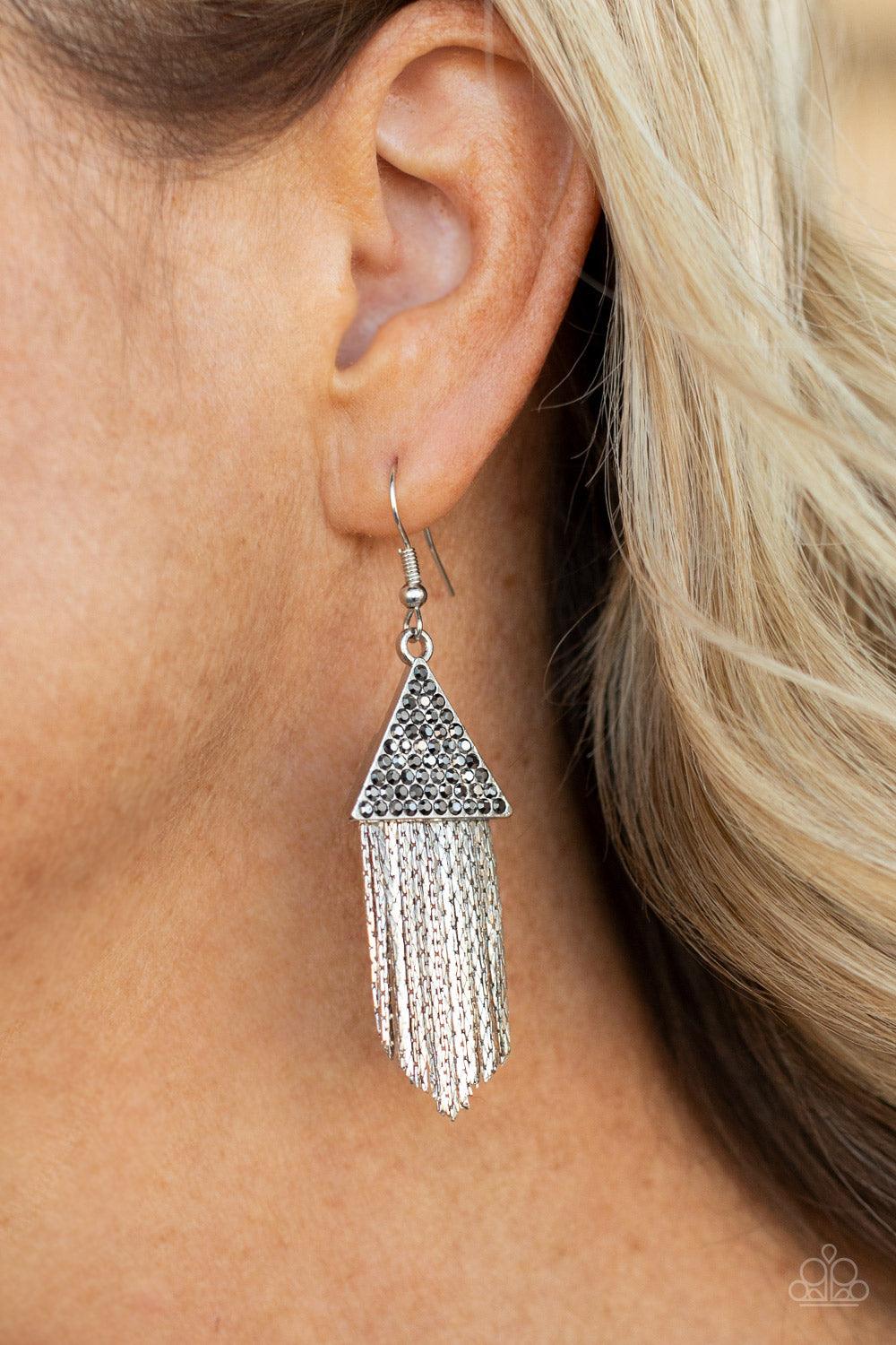 Paparazzi Accessories Pyramid SHEEN - Silver Encrusted in dainty hematite rhinestones, a silver triangle frame gives way to a tapered fringe of flat silver chains for a smoldering effect. Earring attaches to a standard fishhook fitting. Sold as one pair o