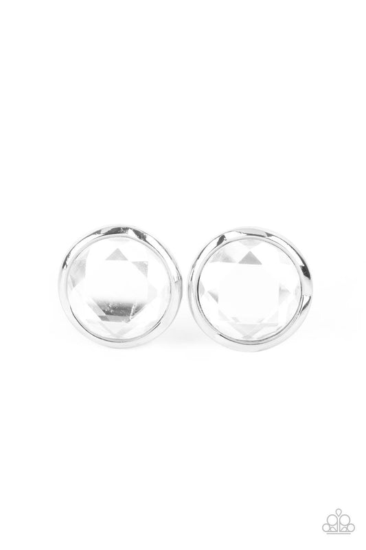 Paparazzi Accessories Double-Take Twinkle - White Featuring a flashy faceted finish, an oversized white gem is pressed into a sleek silver fitting for a dramatic pop of dazzle. Earring attaches to a standard post fitting. Sold as one pair of post earrings