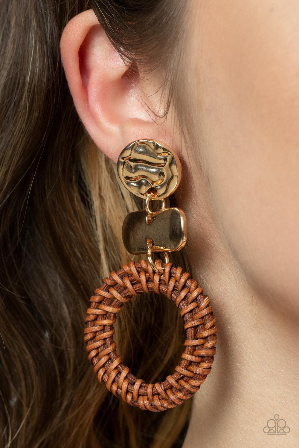 Paparazzi Accessories Woven Whimsicality - Gold A brown wicker-like hoop swings from the bottom of mismatched stacked gold frames, creating an earthy display. Earring attaches to a standard post fitting. Sold as one pair of post earrings. Earrings