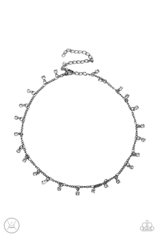 Paparazzi Accessories Bringing SPARKLE Back - Black Encased in gritty gunmetal fittings, glassy white rhinestones dance from the bottom of a dainty gunmetal chain for a dash of spell-binding radiance around the neck. Sold as one individual choker necklace