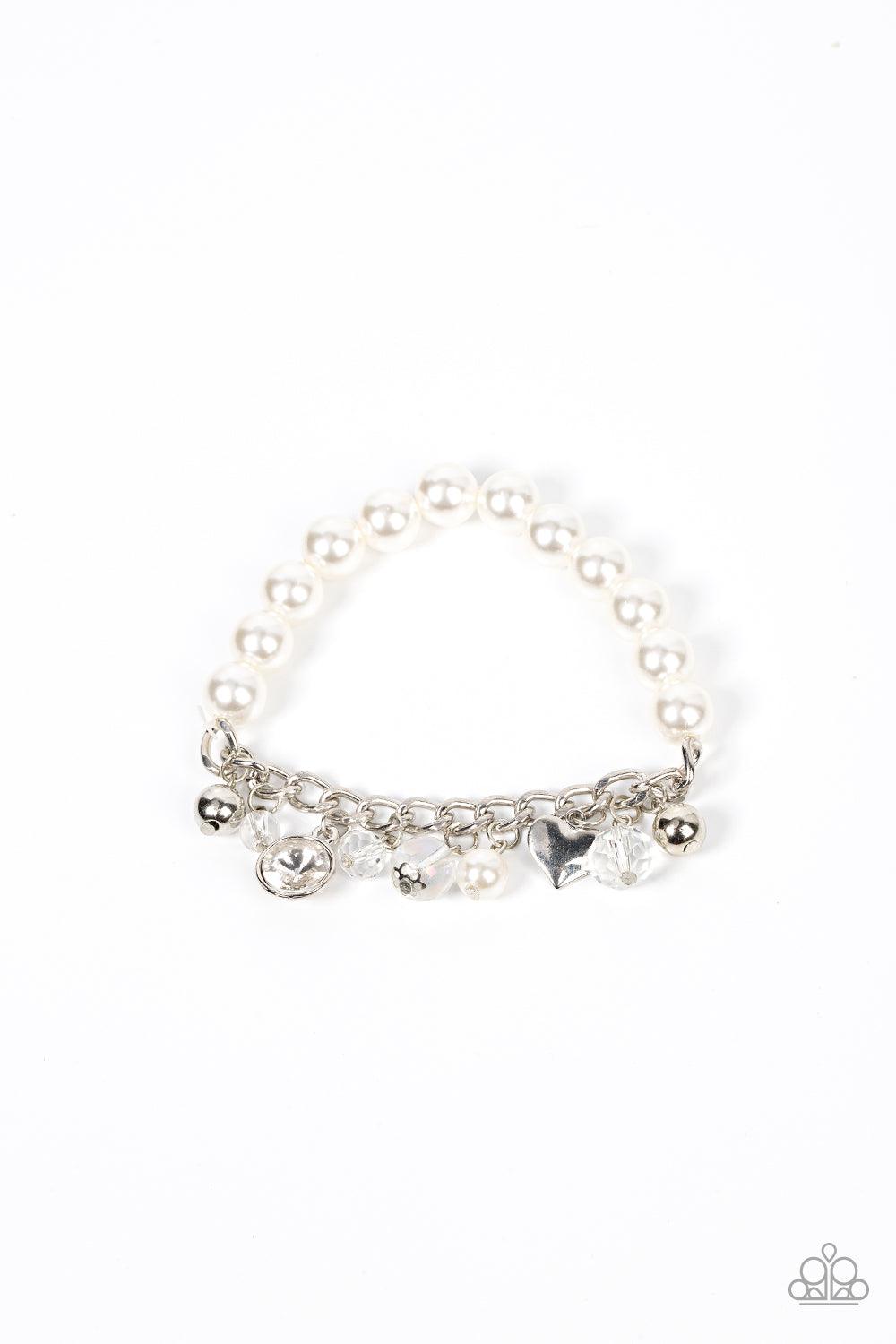 Paparazzi Accessories Adorningly Admirable - White Mismatched silver beads, white pearls, crystal-like accents, gems and heart charms dance from a section of silver chain that attaches to a stretchy band of white pearls around the wrist for a flirtatious