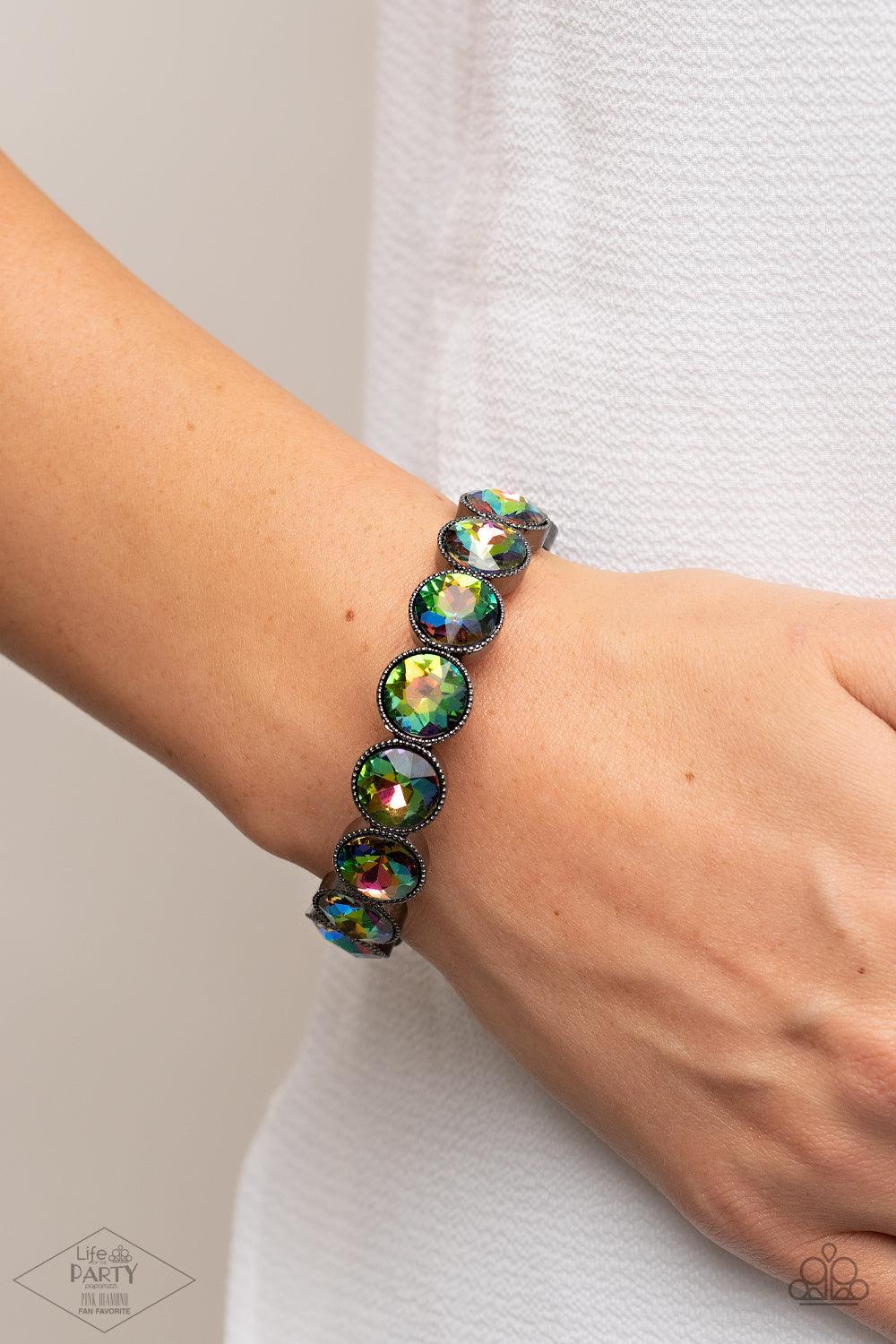 Paparazzi Accessories Number One Knockout - Multi Faceted oil spill gems are pressed into sleek gunmetal frames. The glittery frames are threaded along stretchy bands, creating a glamorous look around the wrist. Sold as one individual bracelet. Jewelry