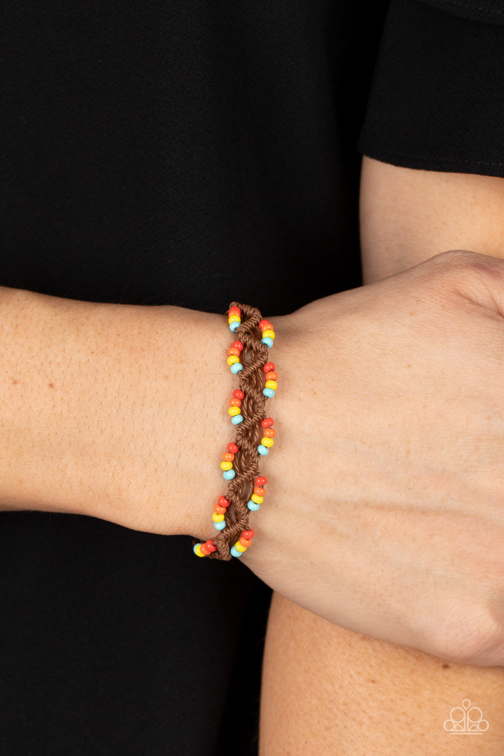 Paparazzi Accessories Cast a Wide Net - Multi Dainty strands of twisted brown cording decoratively weaves into a net-like braid around the wrist. Sections of blue, yellow, orange, and red seed beads are threaded along the edges, creating colorful accents.
