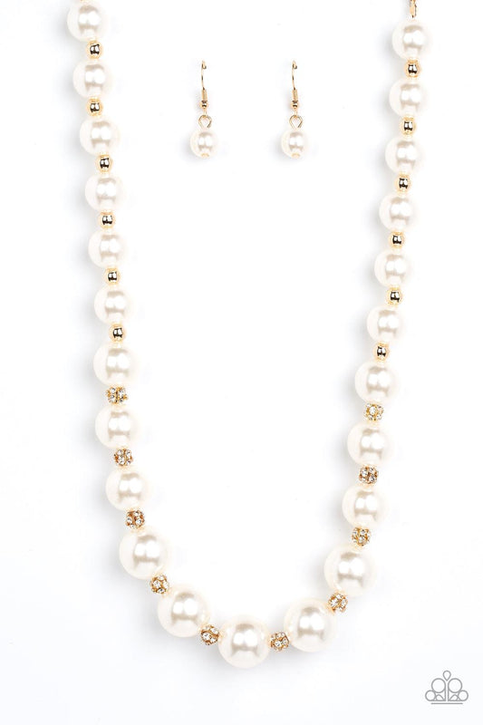 Paparazzi Accessories Sail Away with Me - Gold Gradually increasing in size, bubbly white pearls alternate with glistening gold beads and white rhinestone encrusted accents below the collar for a timeless finish. Features an adjustable clasp closure. Sold