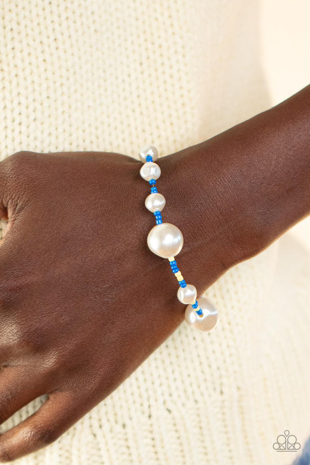 Paparazzi Accessories Contemporary Coastline - Blue Irregular-shaped pearls in varying sizes are scattered amongst blue and yellow seed beads that are threaded along a wire, resulting in a refreshing and playful style around the wrist. Features an adjusta