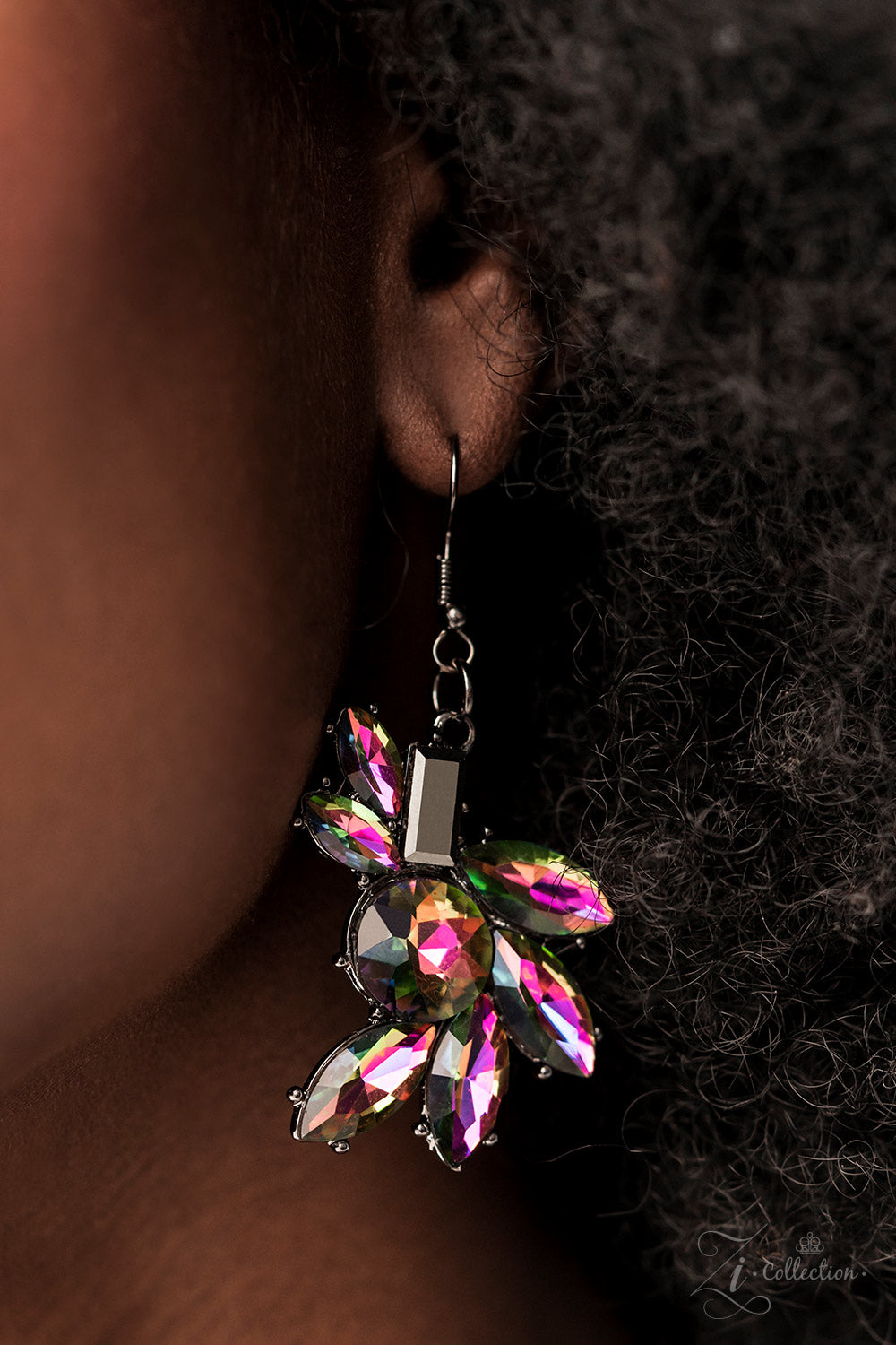Paparazzi Accessories Obsessed Clusters of hematite and oil spill rhinestones link together along the collar, creating an explosion of futuristic sparkle. The faceted edges of each emerald-, round-, or marquise-cut gem exaggerate their dramatic angles and